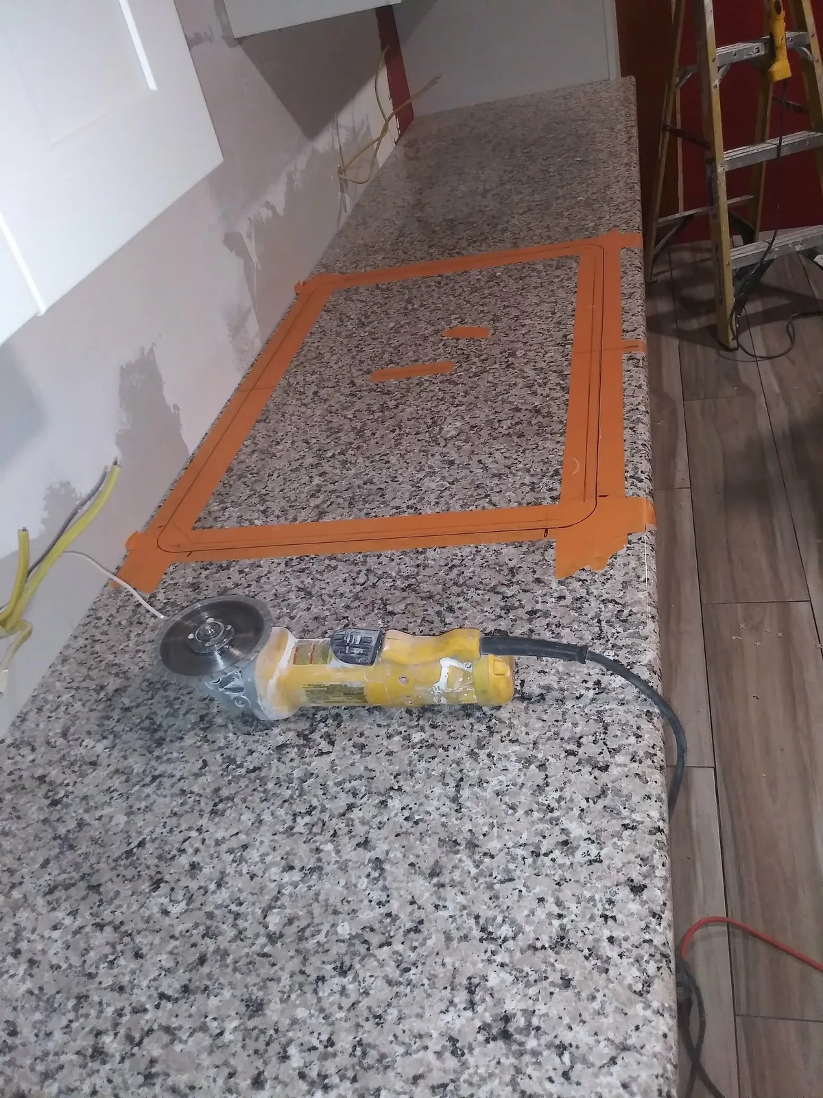 Granite countertop marked and prepared for a cutout