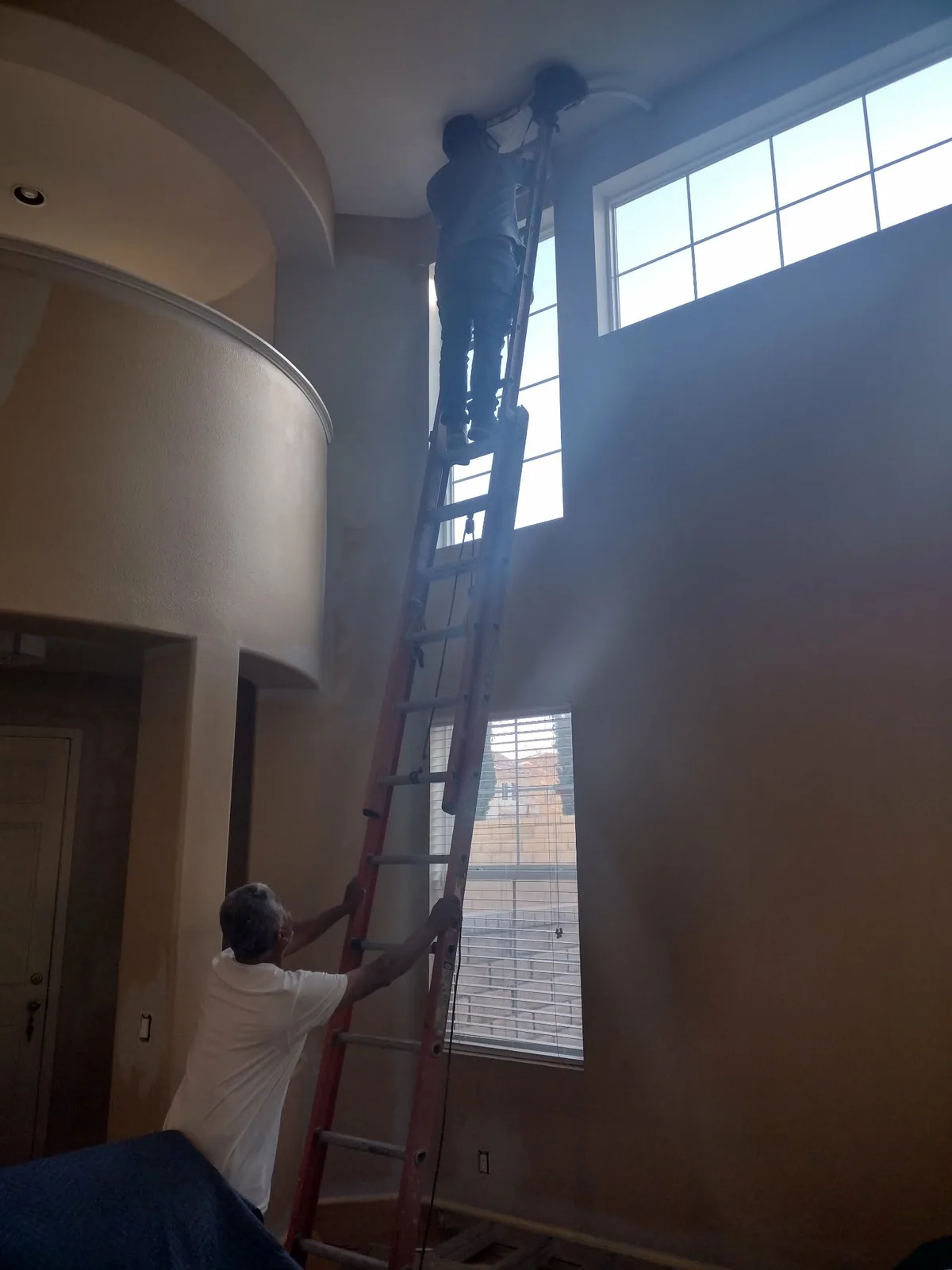 Interior painting on a tall wall above a stairway