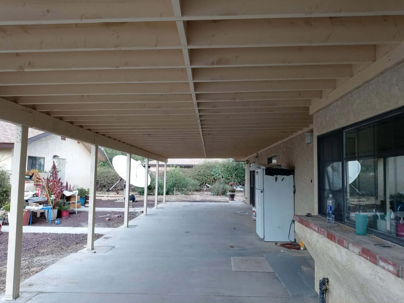 Long painted patio cover extending along a home