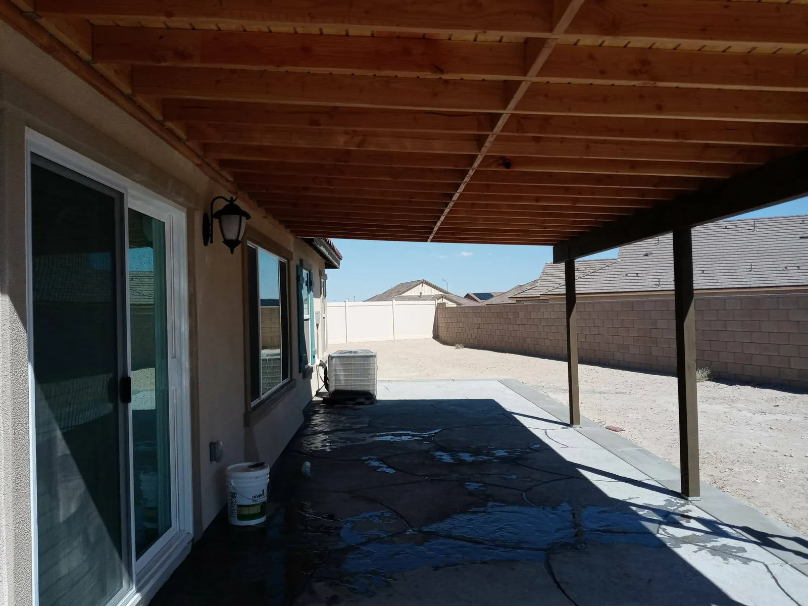 Wood patio cover built over a backyard patio