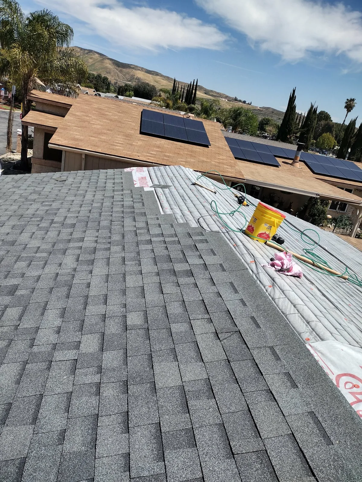 Asphalt shingle roof installation in progress